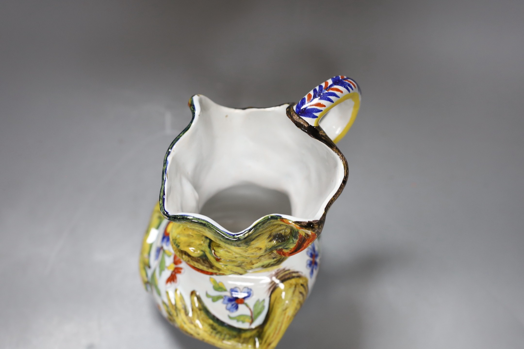A Rouen faience grotesque jug, 19.5 high